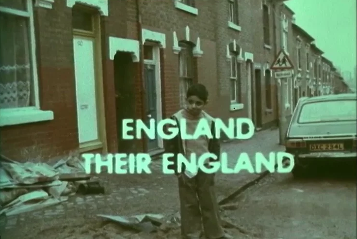 Archive television frame: a boy stands in a terraced street beside a parked car, the title England Their England overlaid.