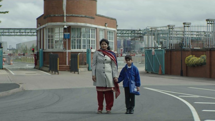 Indi, 2022: a mother and child crossing a Black Country street.
