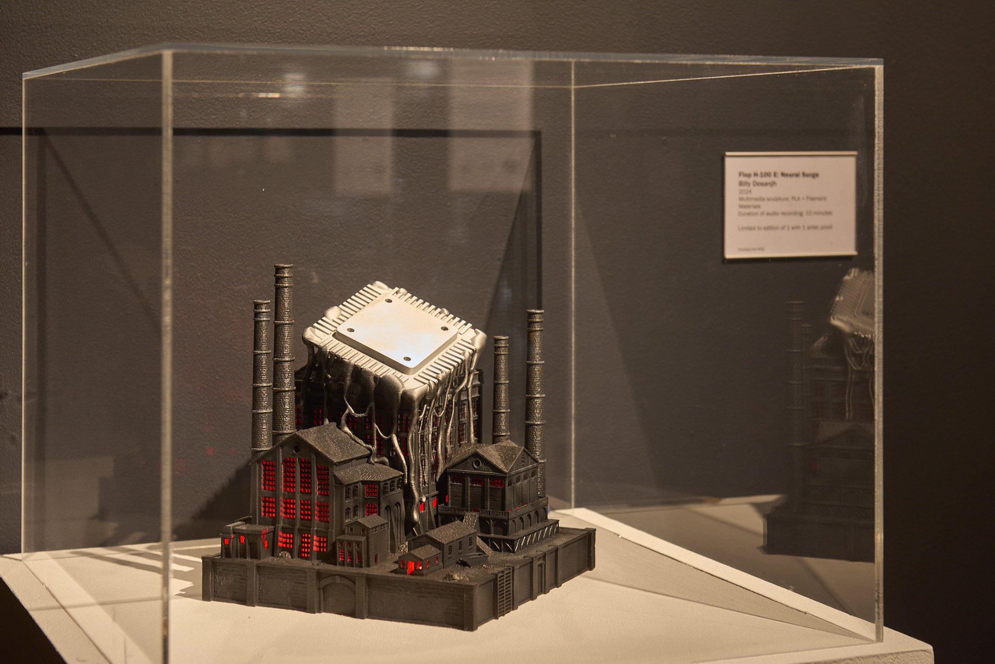 Flop H-100 E: a hand-painted 3D-printed Black Country foundry in a lit acrylic vitrine, factory chimneys reimagined as heat sinks.