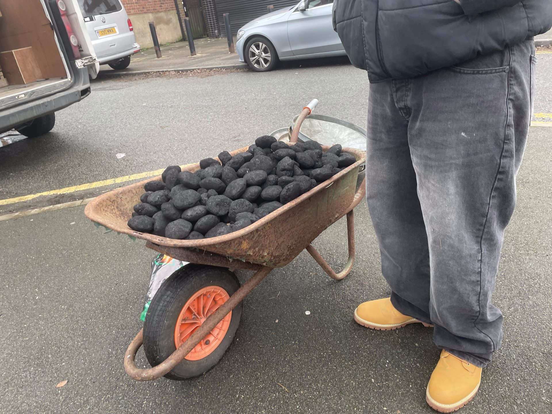 Wheelbarrow of coal on the street