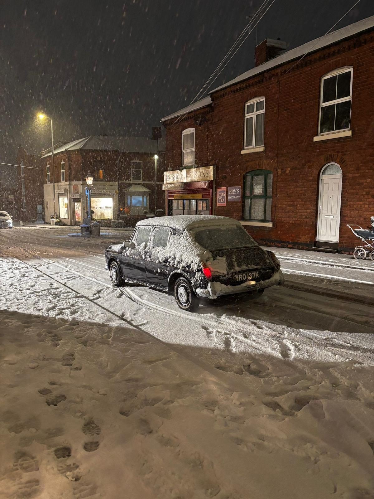 Cast member in turban standing in falling snow