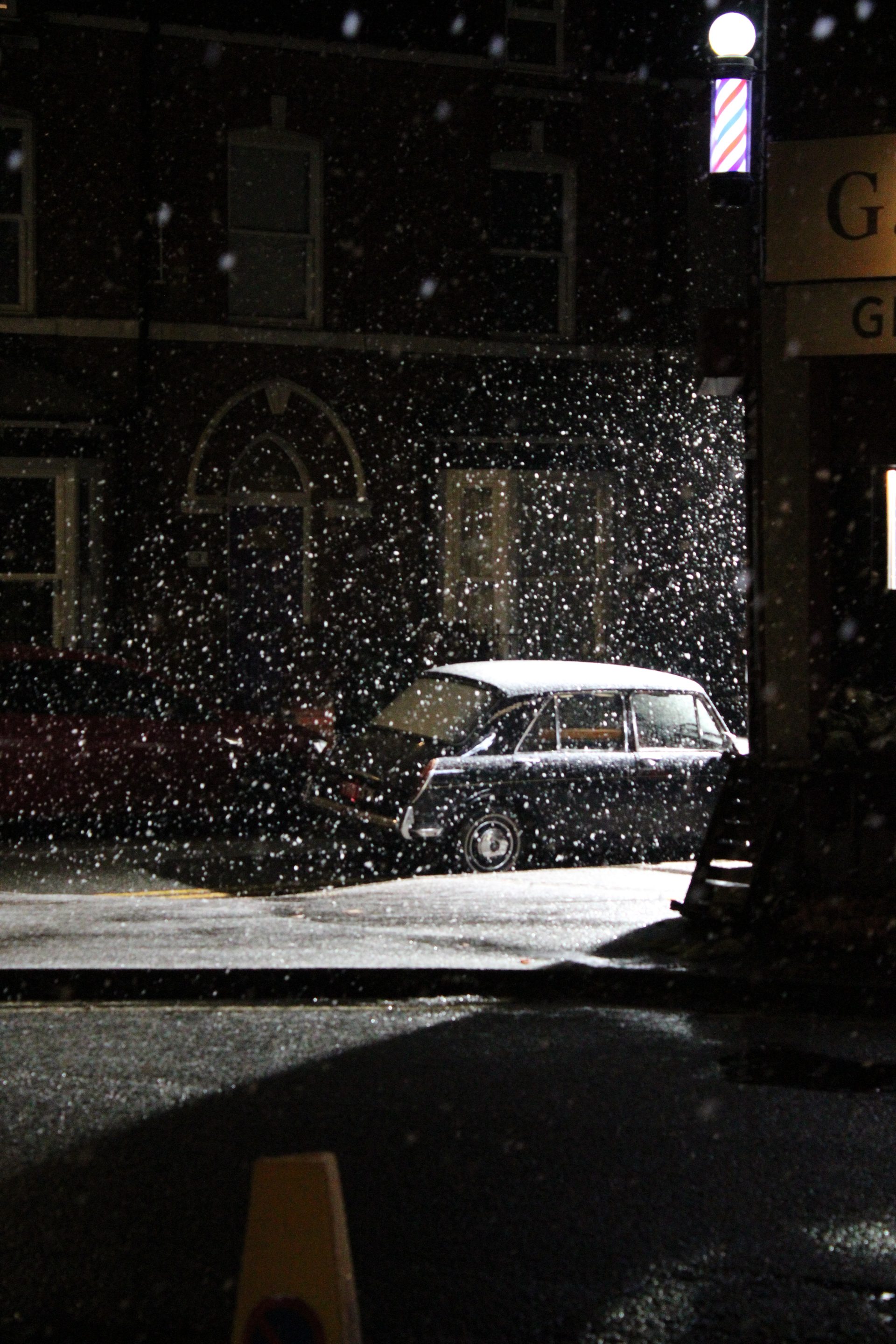 Snow-lit street with period lighting