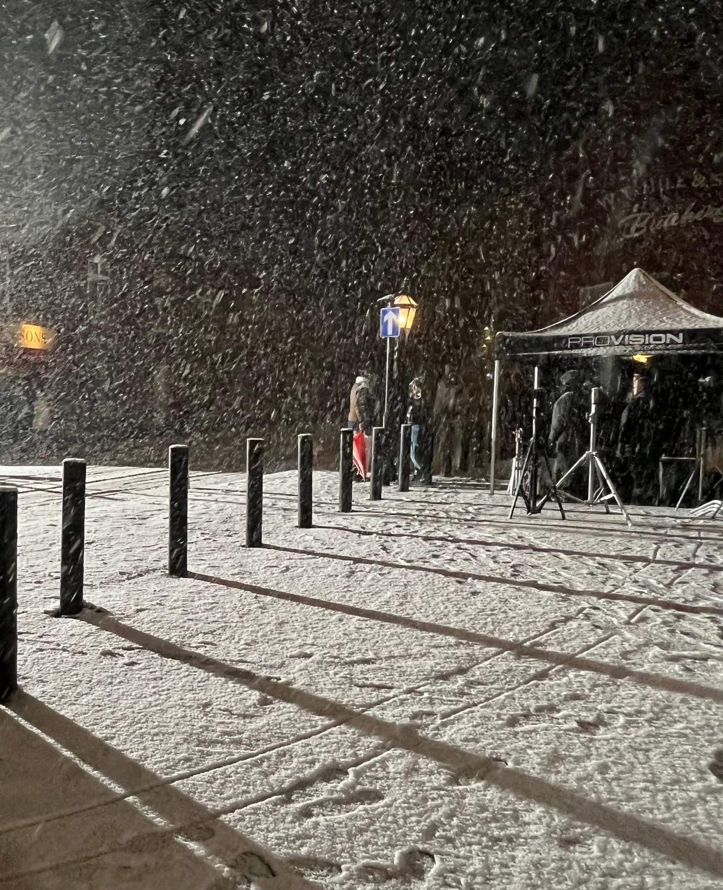 Vintage car on snowy period street