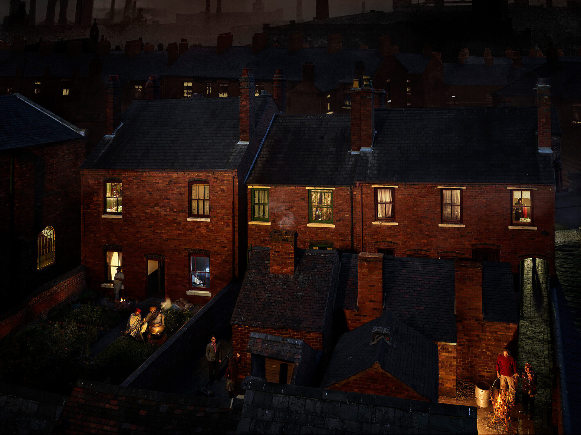 Dayshift, from The Exiles: a cluster of Black Country terraced houses at night, lit windows showing scenes inside, figures gathered in back gardens, factory chimneys silhouetted on the horizon.