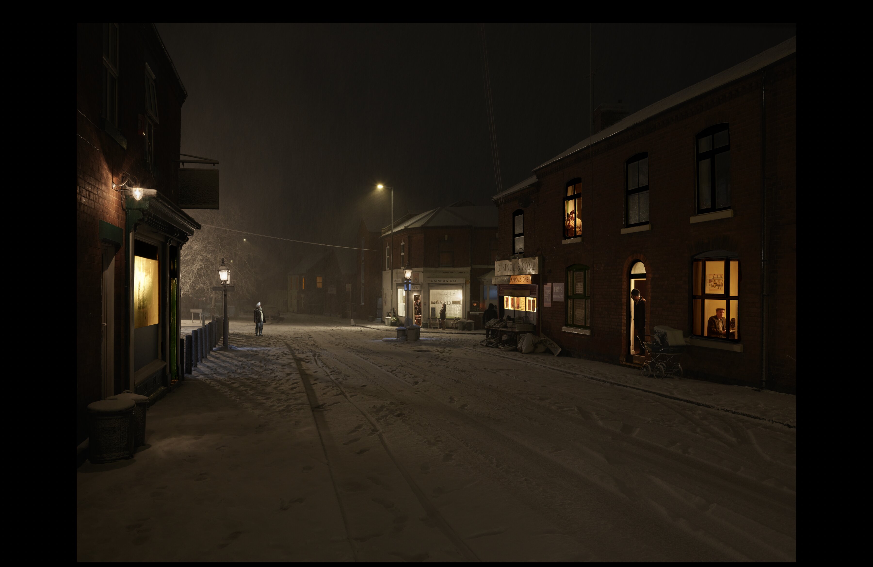 After the Storm, from Paths You Walk: Butts Road, Walsall during the 1962 Big Freeze. Deep snow on the road, period shopfronts including the Rainbow Cafe lit from inside, a solitary figure standing in the white.